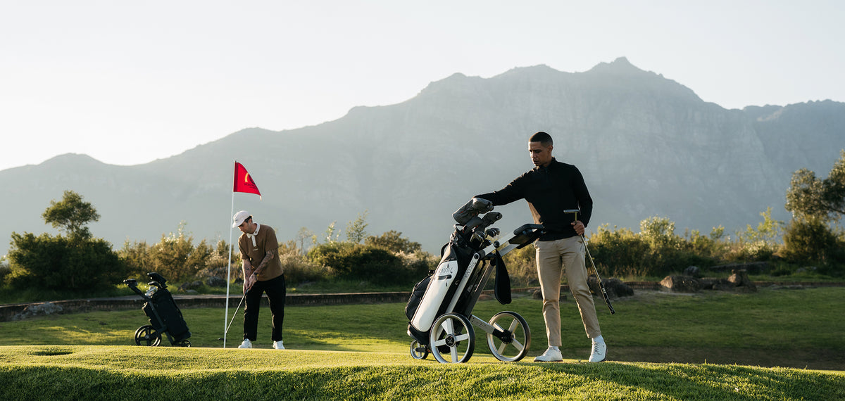 Golfer with a Kaddey trolley and golf bag on a course